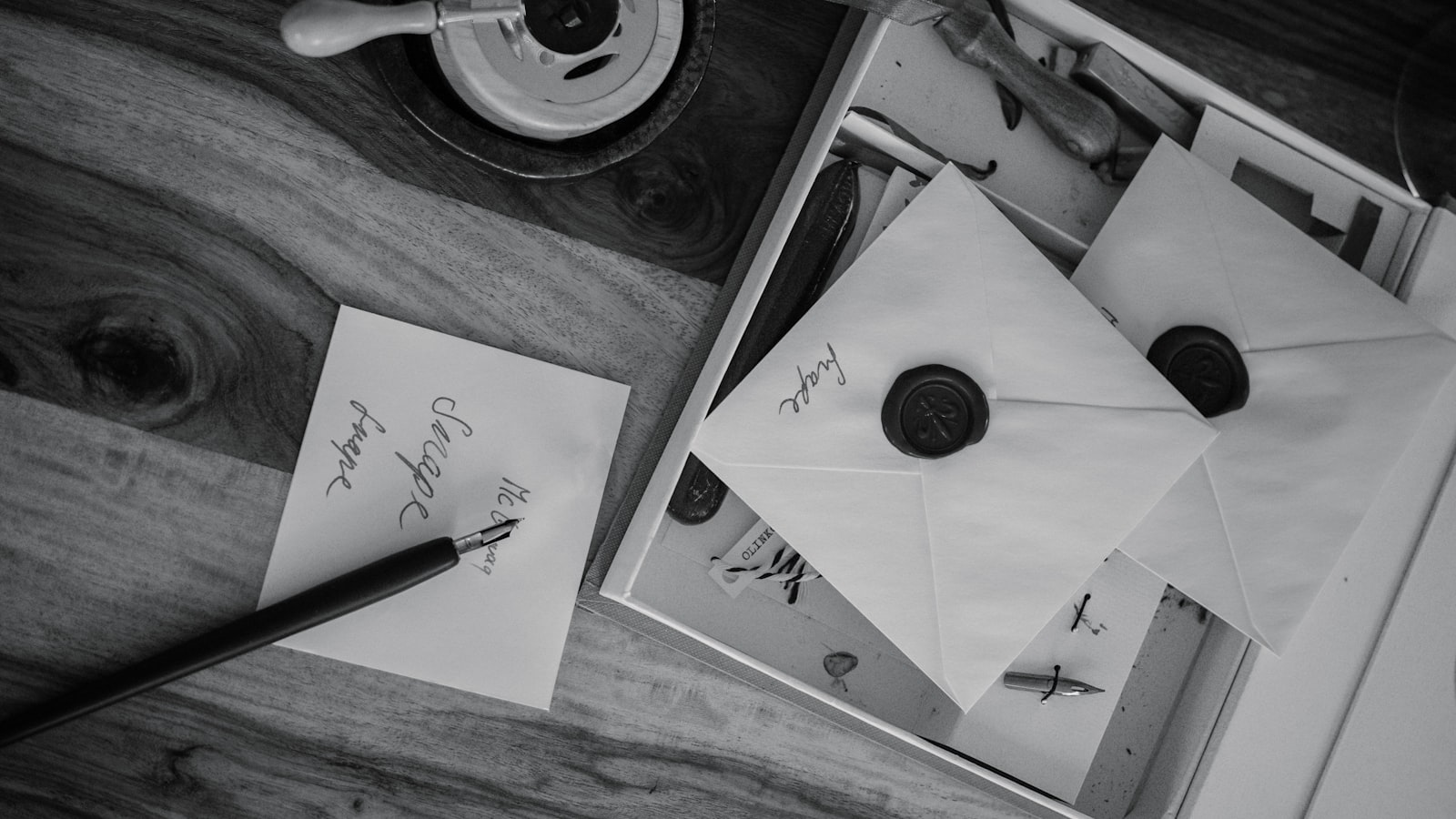 Letters sealed with wax sit on a wooden table.