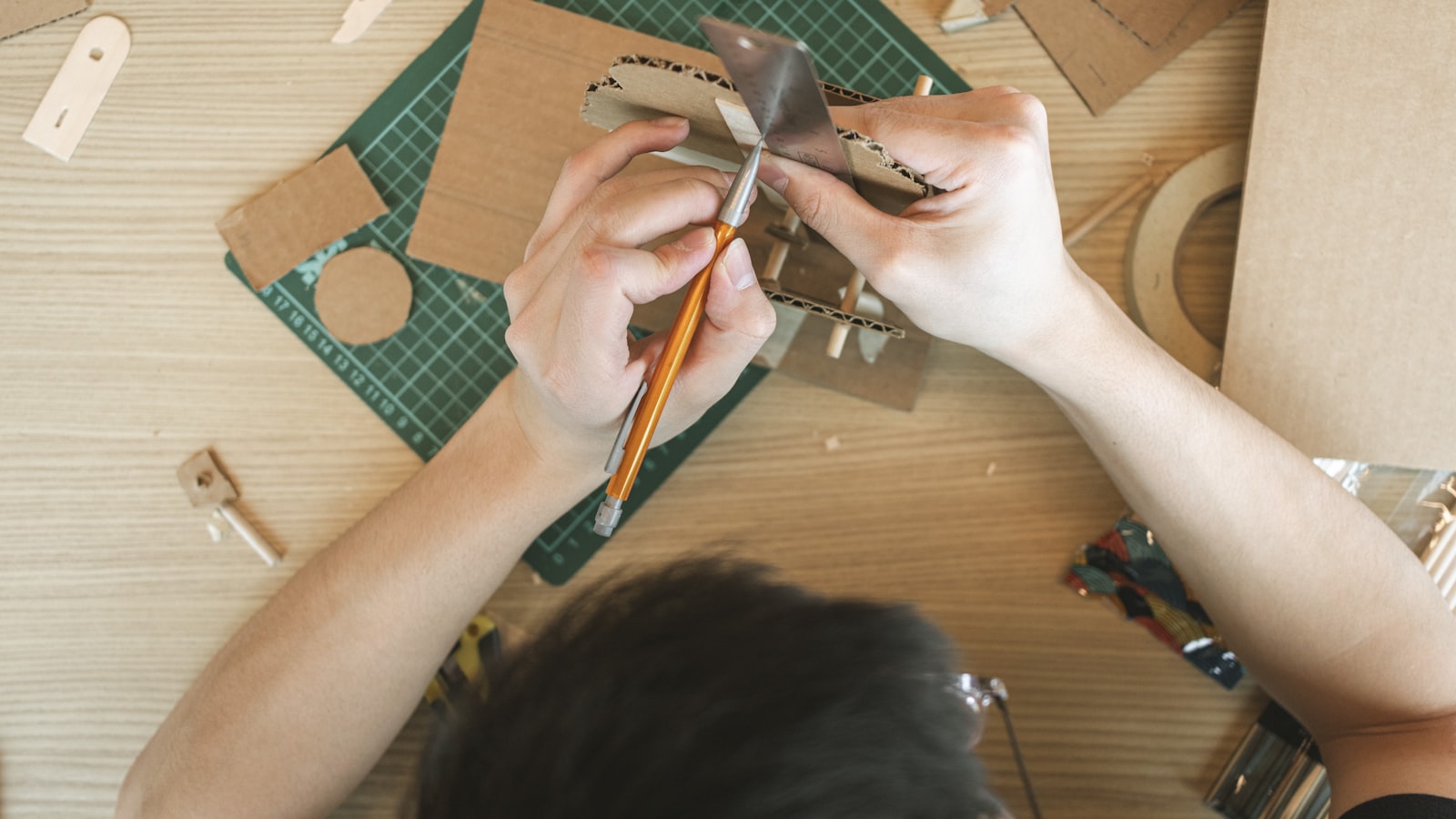 a person working on a craft project on a table