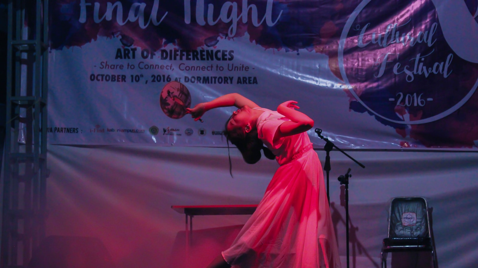 woman in pink dress holding balloons