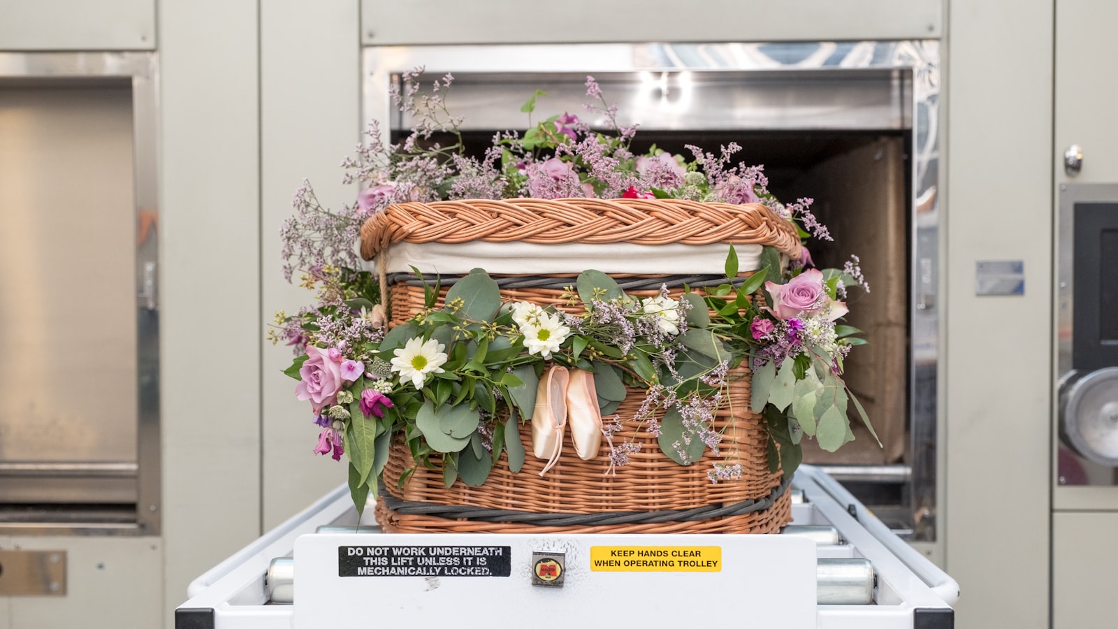 a basket filled with flowers sitting on top of a conveyor belt