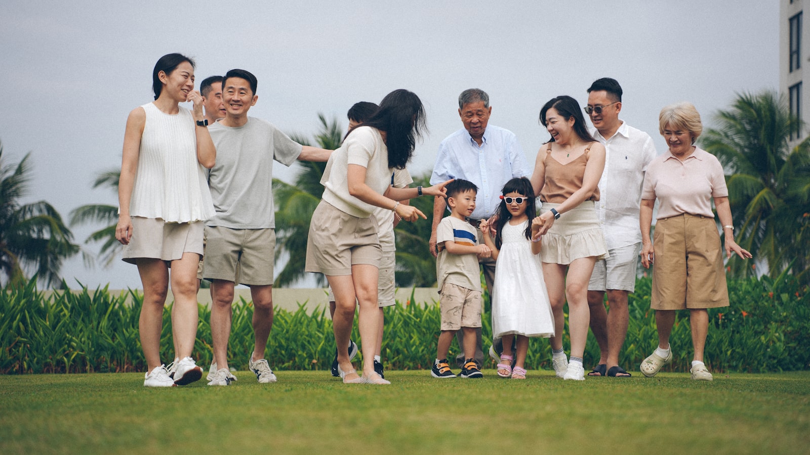 A multigenerational family poses for a photo outdoors.