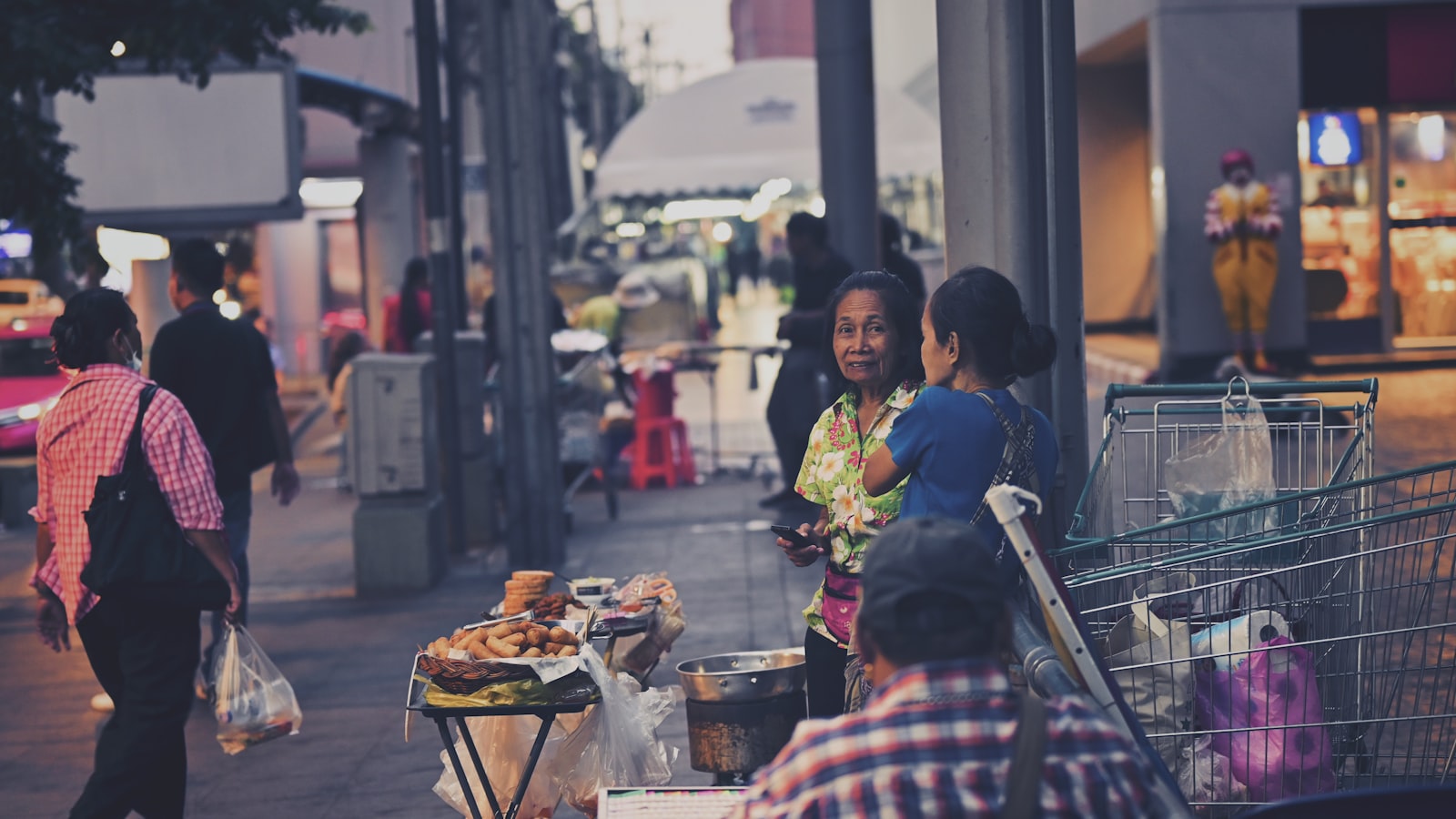 woman in red and white plaid dress shirt sitting on chair in front of table with near near near near