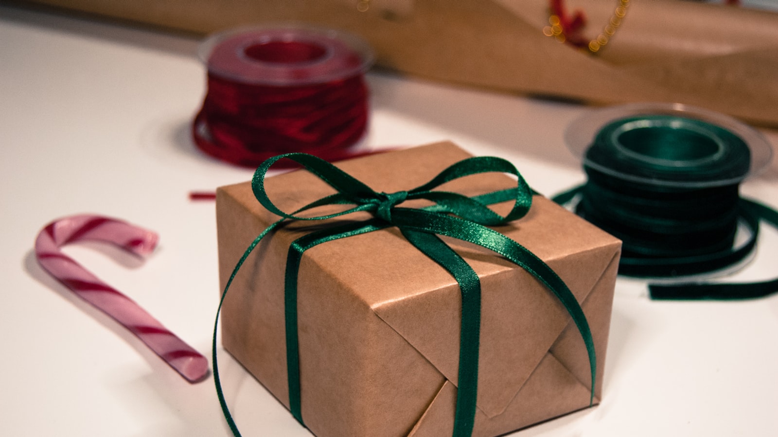 a green and white wrapped gift wrapped gift wrapped in green ribbon