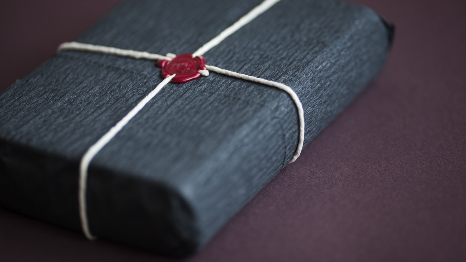 red and white cross pendant necklace on blue and white book