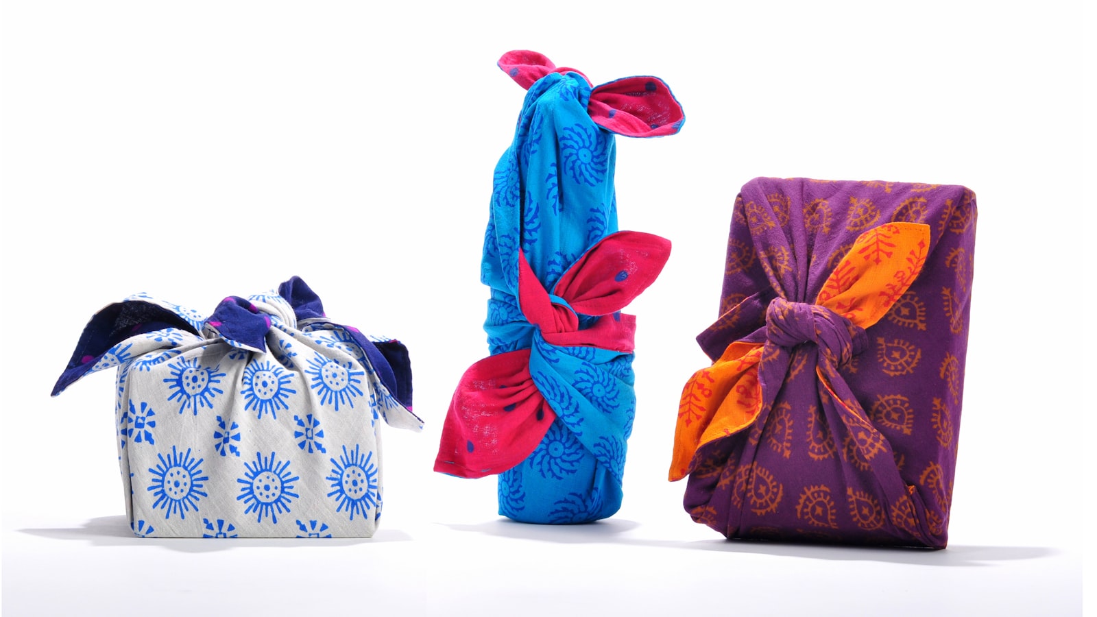 three different colored bags sitting next to each other