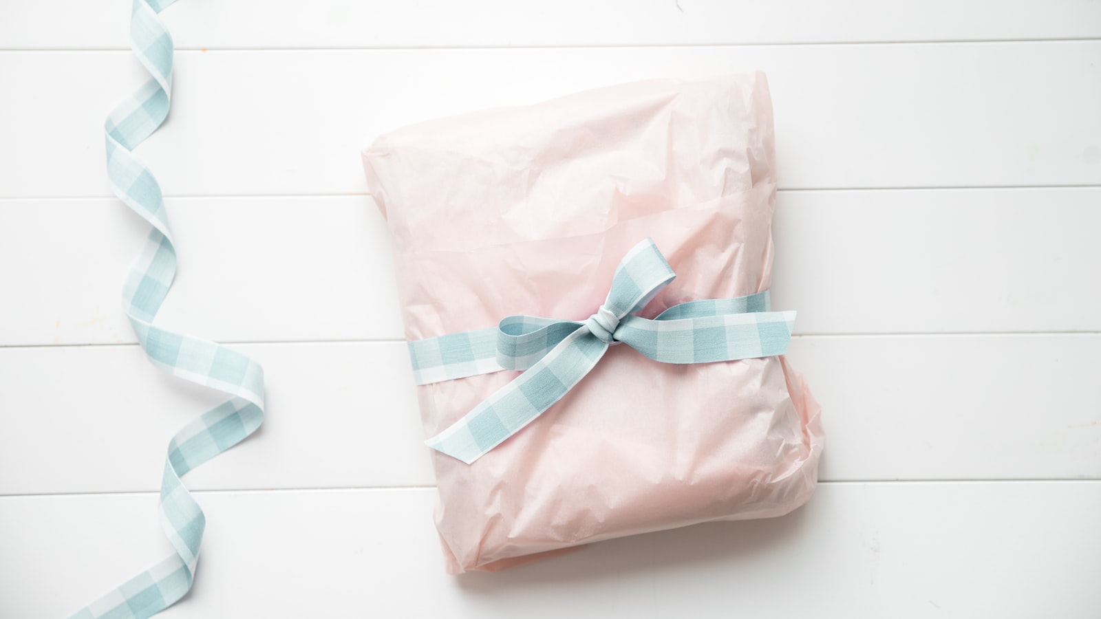 a present wrapped in pink and blue ribbon