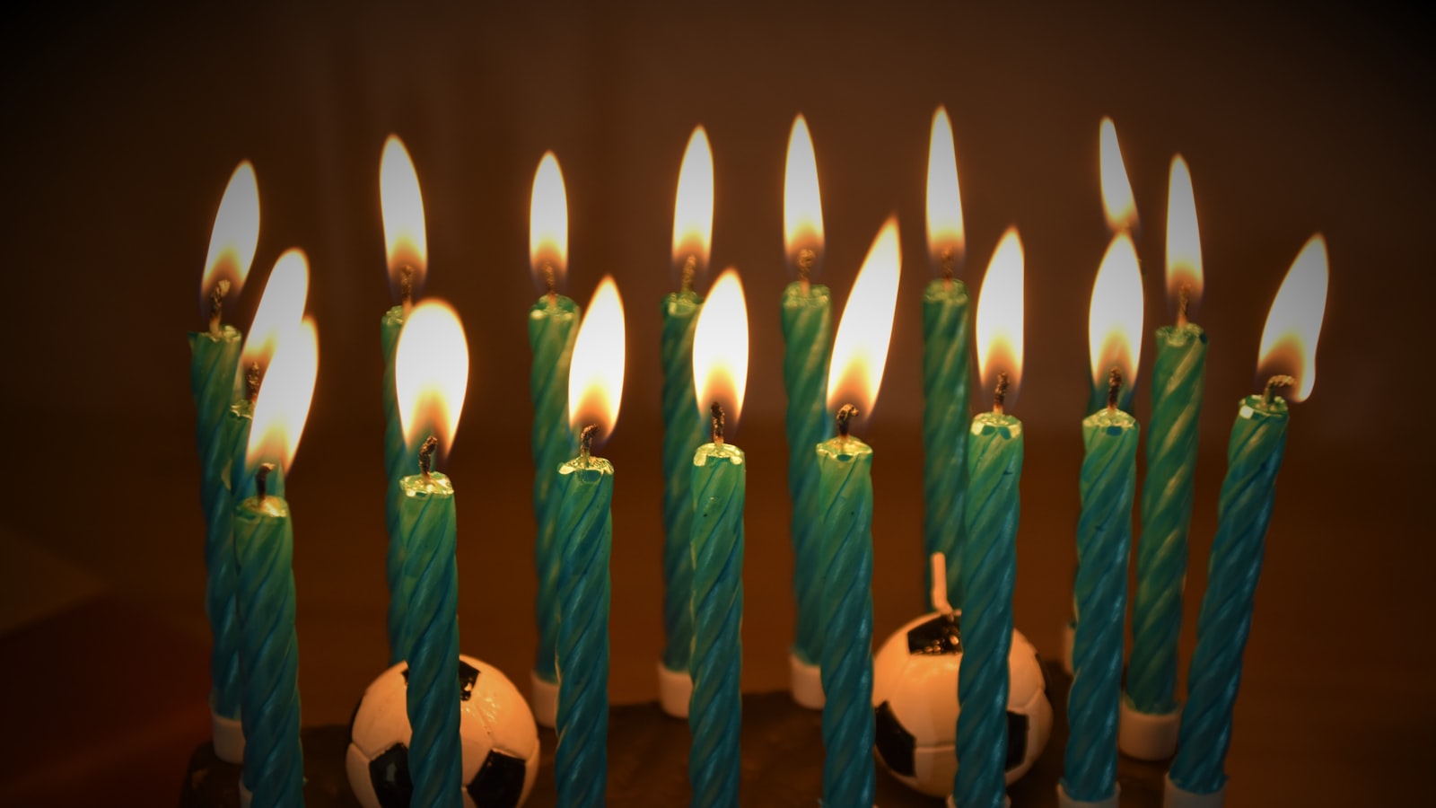 white candles on black surface