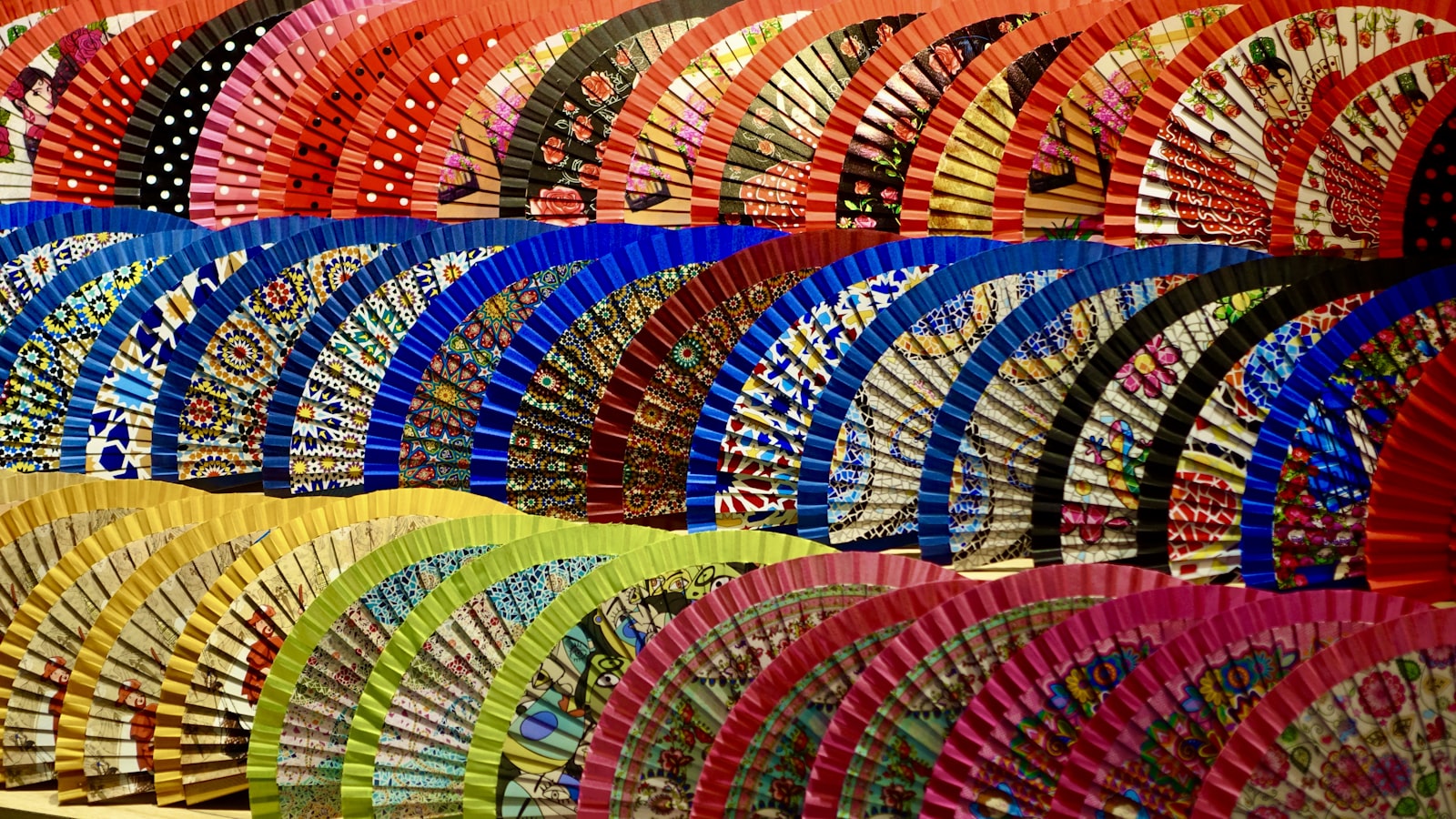 a bunch of colorful umbrellas that are on a shelf