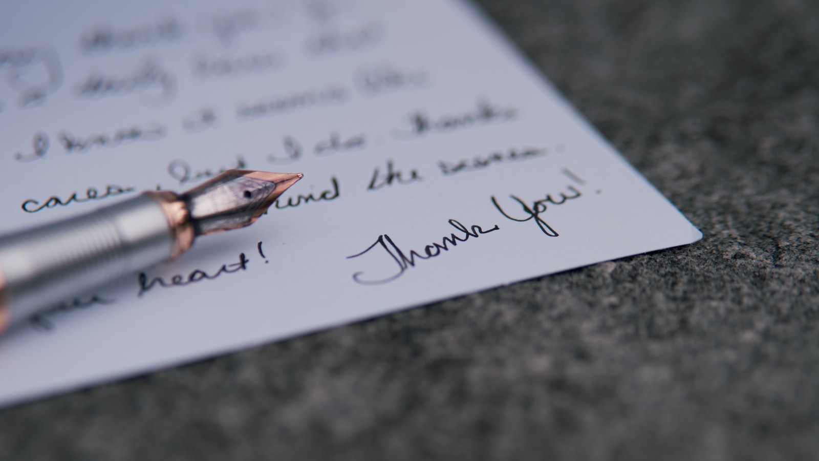 a pen on top of a piece of paper with writing on it