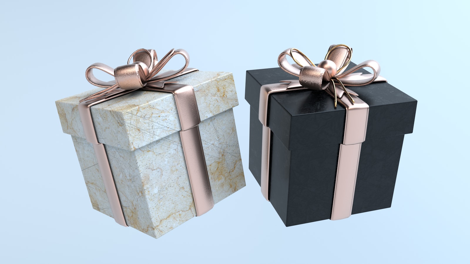 two black and white boxes with gold bows
