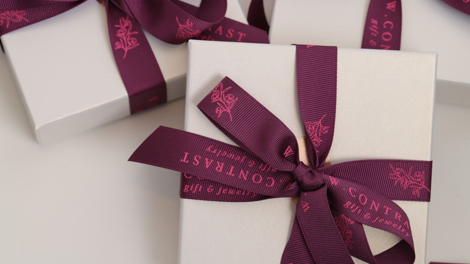 a close up of three wrapped presents with ribbons