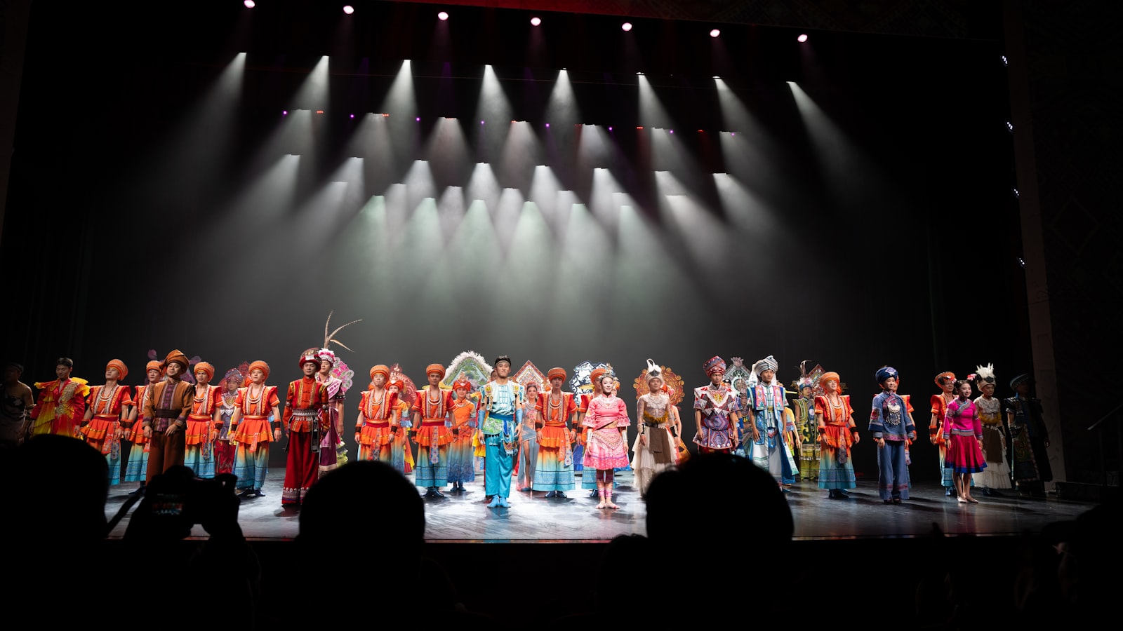 Performers in colorful costumes on a stage.