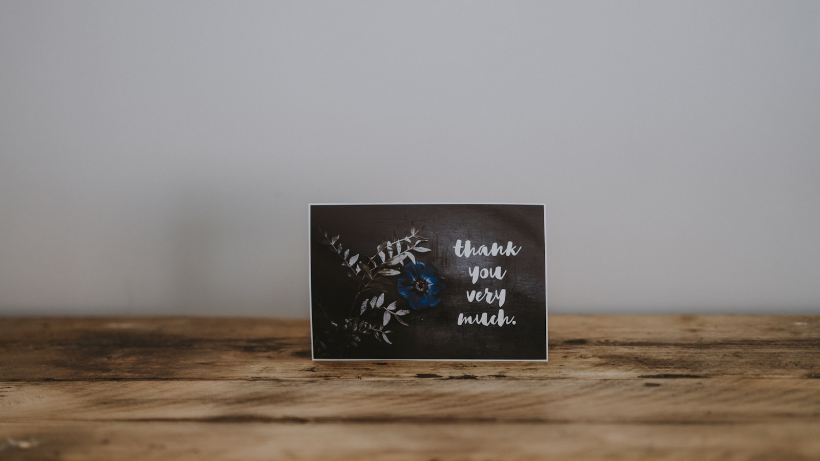 brown and gray quotes board on brown wooden surface